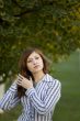 Beauty brunette in a park correct you hairstyle #1