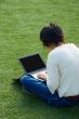 Girl on the grass with a laptop