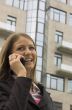 The young woman speaks by phone in the street