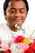 man holds bunch of flowers