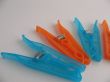 Blue and orange clothes-pegs