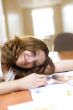 Attractive girl relax on a table after reading fashion magazine