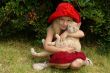 the girl in red hat with a cat