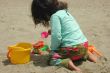 Little girl, sand and toys