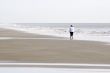 Woman Walking on Beach - Horizontal