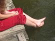 A young girl sits on the bridge