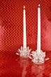 Two White Candles in Crystal Candleholders with Red Backgrounc