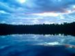 dramatic sunset over placid lake