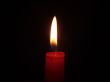 The red candle burning in full darkness