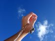 Hand with small headphones