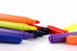 Felt pens with lids next to them