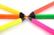 Neon pencils pointing at each other