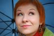 young red-haired woman with umbrella
