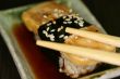Omelette sushi with chopsticks