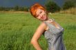 red-haired beautiful woman in dress in field