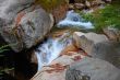 water falls over granite boulders