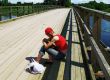 girl waiting on wooden bridge