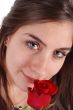 Young girl smelling a rose