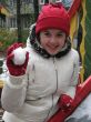The girl in red hat with snowball