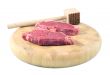Steaks on a chopping board with Mallet