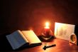 book and burning candle
