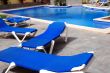 pool with blue chairs around it