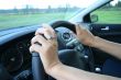 A woman driving her car.