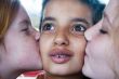 girls kissing boy