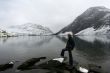 snow mountain with cold lake and young woman