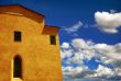 yellow building with cloudy sky in the background