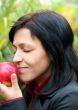 woman and apple in autumn park