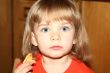 Little pretty blond girl eating pancake
