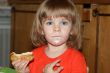 Little pretty blond girl eating pancake