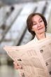 business woman reading a newspaper