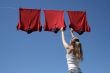 Girl, blue sky and red laundry