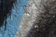 Graffiti detail on a grainy concrete wall