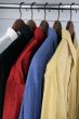 Colorful shirts on wooden hangers