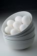 Eggs in stacked white bowls