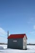 Ice fishing hut under the blue sky