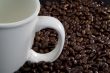 Coffee beans and white coffee cup