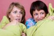 Two girl watching a scary movie