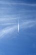 Jet airplane crossing the sky like a comet
