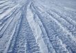 Car tracks crossing the snowy terrain