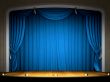 Empty stage with blue curtain in expectation of performance