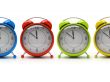 Four colourful alarm clocks isolated on white background 3D