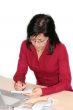 woman in office is writing