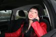 woman in a car show a tounger and calling by mobile phone