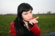 woman show a kiss in park