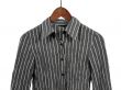 Gray striped shirt on wooden hanger, isolated