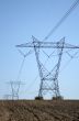 Electricity pylons in ploughed land